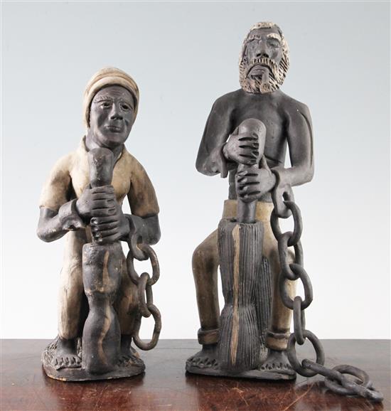 A pair of West Indian ceramic figures of slaves, largest 14.5in.